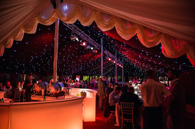 traditional pole marquee with black starlight ceiling and truss lighting and illuminated bars