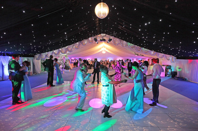 dorset wedding marquee LED uplights, white dance floor, black starlight ceiling and light blue carpet
