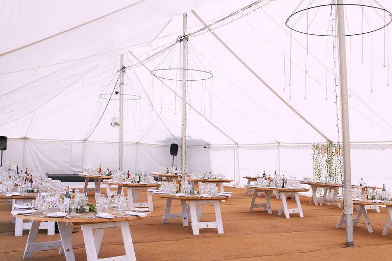 dorset wedding traditional marquee with coconut matting and rustic round tables