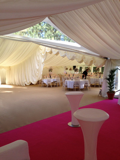 oakleaf marquees Clear roof cruciform section linking a 12m frame marquee to 9m in a T shape. Coffee and pink carpets.

