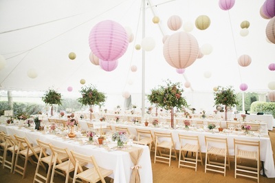 dorset wedding Traditional marquee, 80 lit paper lanterns, folding wooden chairs, matting and long tables.