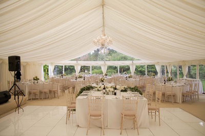 wedding marquee with white dance floor and crystal chandeliers