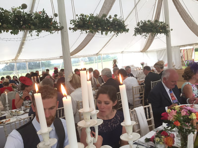 Dorset wedding traditional marquee with hanging rustic floral planks and hessian drapes
